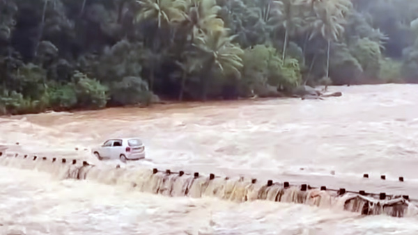 Man Crosses Flooded Kerala Bridge